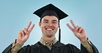 Graduation, man and peace sign at studio, smile and face for achievement, goals or pride by blue background. College student guy, hand icon and emoji in portrait for education, celebration or success