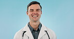 Happy, surgeon and portrait of doctor confident and smile for happiness isolated in studio blue background. Healthcare, professional and medical employee, expert or worker in medicine service