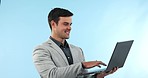 Laptop, happy and young businessman in studio typing for research for a legal case with technology. Smile, pride and professional male attorney working on law report with computer by blue background.