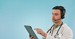 Doctor, tablet and call center for healthcare communication, virtual consultation and telehealth services in studio. Professional medical man talking, headphones and digital tech on a blue background