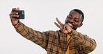 Online, black man or influencer taking a selfie in studio on social media with peace sign. Fashion, smile or cool happy African person taking a photo, vlog or picture isolated on white background