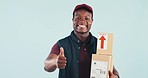 Delivery man, boxes and thumbs up in studio with face, smile and service for supply chain by blue background. African courier, cardboard package and icon for commerce, logistics or emoji for review