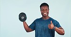 Fitness, man and dumbbell with thumbs up for exercise, training or workout in studio on blue background. Weightlifting, person and personal trainer for wellness and healthy body with smile at gym