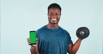 Happy black man, phone and dumbbell with green screen for fitness app against a studio background. Portrait of African active male person or bodybuilder smile with mobile smartphone display or mockup