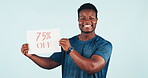 Happy man, announcement and holding poster in studio, advertising and discount on promotion offer. African guy, smile and marketing with billboard on retail shopping and price information for sale
