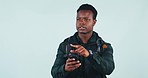 Phone, directions and black man in a studio for adventure, journey or tourist vacation with technology. Online map, cellphone and young African male model with backpack for hiking by white background