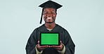 Happy black man, tablet and green screen for graduation or advertising against a studio background. Portrait of African male person, student or graduate smile showing technology app display or mockup