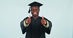 Happy black man, graduation and thumbs up in success or winning against a studio background. Portrait of African male person, student or graduate smile with like emoji, yes sign or OK for thank you