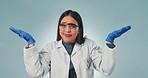 Scientist woman, hand and choice in studio for thinking, options or review with doubt by blue background. Doctor, gloves or ppe glasses with open palm for decision, face or feedback on research data