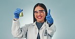 Doctor, thumbs up and sample with a science woman in studio on a gray background for research or innovation. Portrait, success and chemical biology with a young scientist working on a breakthrough