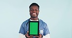 Nurse, black man showing tablet and green screen in studio for telehealth, online healthcare or expert advice. Medical professional, caregiver or doctor with digital app for health on blue background