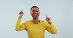 Smile, dance and music with a black woman in yellow on a blue background in studio for energy. Portrait, happy and freedom with a young person moving to audio or the sound of radio streaming