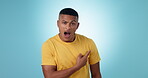 Pointing, shock and wow with face of man in studio for announcement, surprise and presentation. Information, offer and giveaway with portrait of person on blue background for alert and promotion