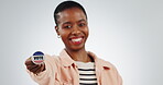 Hand, vote and badge with black woman for election, politics and support in studio on white background. Portrait, person and voting with happiness for human rights, democracy or choice of usa party