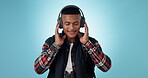 Headphones, happy man and dancing studio with music, radio or audio with energy on blue background. Listen, dancer and person with digital media streaming hip hop, sound or podcast for freedom