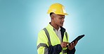 Construction worker man, tablet and thinking in studio for development, survey or planning by blue background. Builder, contractor or architect with touchscreen, brainstorming or inspiration with app