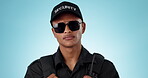 Security guard, studio face and man confident in protection, job experience or law enforcement trust, help or crime support. Public service portrait, cop glasses and police officer on blue background