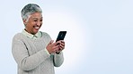 Senior woman, phone and studio by space for mockup, laugh or chat for funny meme by blue background. Mature lady, smartphone and reading on social media app, comic video or thinking for web promotion