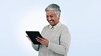 Tablet, search and happy senior woman laugh in studio with social media, streaming or meme on blue background. Digital, news and elderly female with app sign up for funny chat, gif or communication