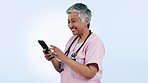Nurse, woman and video call or phone communication for healthcare, social media or telehealth services in studio. Happy and mature doctor talking on mobile voip for medical advice on blue background