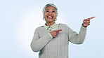 Smile, presentation and pointing with a senior woman in studio on a blue background for marketing. Portrait, about us and review with a happy elderly person looking excited by a sale, deal or offer