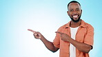 Man, face and advertising presentation in studio of information, deal and choice on blue background. Happy portrait of african model pointing to mockup space, announcement and launch of news about us