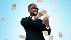 Happy businessman, money rain and celebration for lottery, investment or saving against a studio background. Rich man smile for cash flow, paper bills or salary bonus in wealth or financial freedom