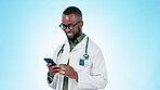 Doctor, man and happy with phone in studio for online contact, reading medical notification or telehealth info on blue background. African surgeon, laugh or typing on smartphone to search digital app