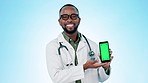 Face, doctor and green screen of phone in studio for advertising, review and offer telehealth information to you on blue background. Portrait, black man and mobile tracking markers for medical advice