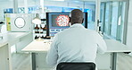 Computer, black man or scientist reading in laboratory for chemistry research report or bacteria feedback. Medical analysis, back view or doctor on search online for medicine news on desktop screen