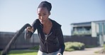 Fitness, battle ropes and black woman doing exercise in nature for strength, weight loss and body training. Sports, wellness and young African female athlete doing workout at an outdoor park or field