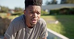 Black man, fitness and running in nature for workout, cardio training or outdoor exercise. Tired and active African male person or runner taking break, rest or breathe for recovery after run at park