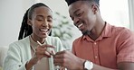 Sushi, chopsticks and couple in home and hands helping or black man teaching woman to eat with tools. Food, date and sharing culture practice or utensil sticks in apartment or house with happy people