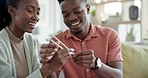 Sushi, chopsticks and couple in home and hands learning or black man teaching woman to eat with tools. Food, date and sharing culture practice or sticks in apartment or house with happy people