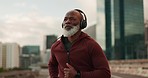 Senior, fitness and black man running in a city street with music headphones, podcast or energy. Workout, training and elderly African male runner with radio earphones in a road for cardio exercise
