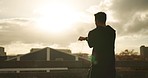 Morning, stretching and man on a city bridge with fitness, workout and running for wellness. Male person, back and start for marathon training and exercise for run on urban road outdoor with athlete