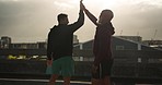 Morning, high five and men on a city bridge with fitness, workout and running for wellness. Friends, success and support for marathon training and exercise for run on urban road outdoor with athlete