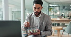 Laptop, salad and a business man eating in the office while working on research for a report. Computer, food and a young vegetarian employee with a health snack in the workplace for diet or nutrition