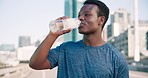 City, fitness or black man drinking water, exercise or workout with wellness, challenge or training. Healthy person, athlete outdoor or runner with bottle, liquid or fatigue with hydration or thirsty