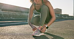 Tying laces, fitness and a woman in the city for running, sports or training in the street. Health, hiking and a runner or female athlete getting ready for exercise, marathon or cardio with shoes