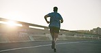 Black man, fitness and running on road in sunset for workout, outdoor exercise or cardio training in city. Rear view of active male person, athlete or runner in sport, healthy wellness or lose weight