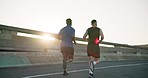 Man, friends and running in city for fitness workout, outdoor exercise or training together in urban town. Rear view of active runners or athletes in sprint, cardio or sports marathon or race on road