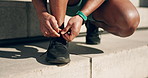 Hands, shoes and tie with a sports person on a step, getting ready for a workout as a runner in the city. Fitness, running and feet of an athlete in an urban town in preparation for cardio training