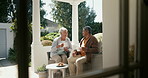 Senior couple, drinking coffee and happy in outdoors, retirement and love for bonding, marriage and trust. Smiling old mexican people, support and relax on porch with food and morning conversation