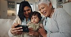 Selfie, woman and senior grandmother with baby bonding together on a sofa for relaxing at home. Happy, smile and female person taking a picture with elderly person in retirement with child in lounge.