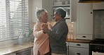 Retirement, home and dancing senior couple with love in house, kitchen or living room with care and support together. Happy, elderly people and dance with freedom, peace and happiness in marriage