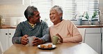 Senior couple, laughing and bonding in kitchen with coffee, retirement and conversation in house. Happy people, funny or joke together in home with biscuits, cookies or morning tea at breakfast table