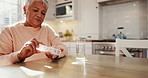 Old woman with pills in kitchen, health and supplements for wellness or sick, water and daily routine at home. Retirement, treatment with medicine and healthcare, drugs in container and vitamins