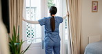 Nurse, morning and opening curtains by a door in an assisted living home at the start of a day. Healthcare, smile and a young caregiver in the lounge of a retirement house for professional care