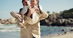 Happy, father and spin child on beach, nature or outdoor on holiday, vacation and bonding together with game. Playing, dad and girl with support in air, flying or happiness at ocean or sea in Brazil